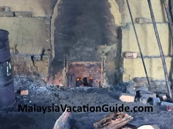 Final stage of closing the kiln to make charcoal from the mangrove trees